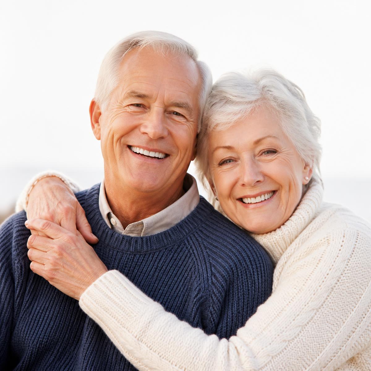 Smiling older couple reviewing their life insurance coverage together
